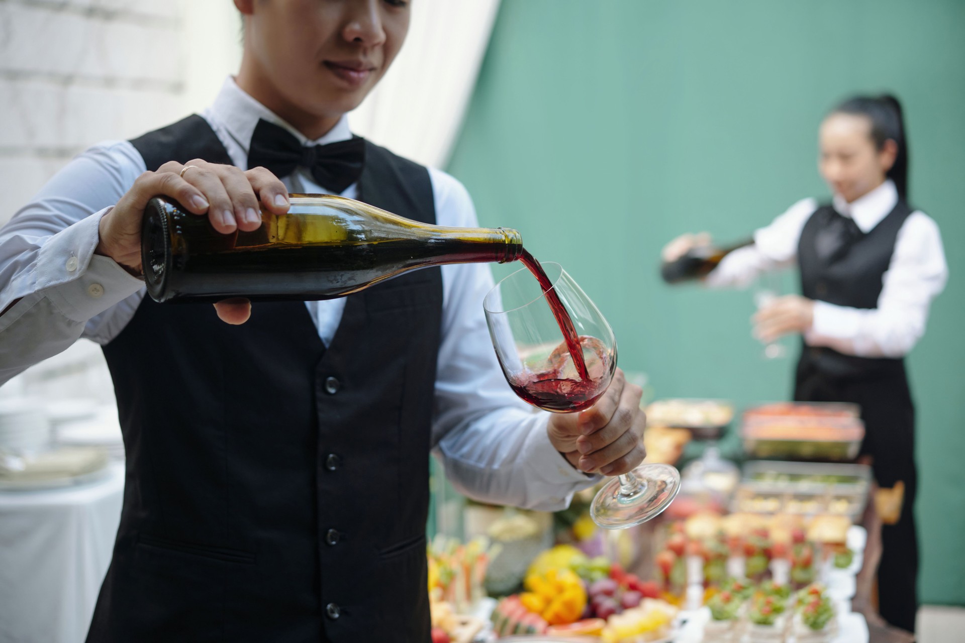 Pouring Red Wine at Elegant Outdoor Event